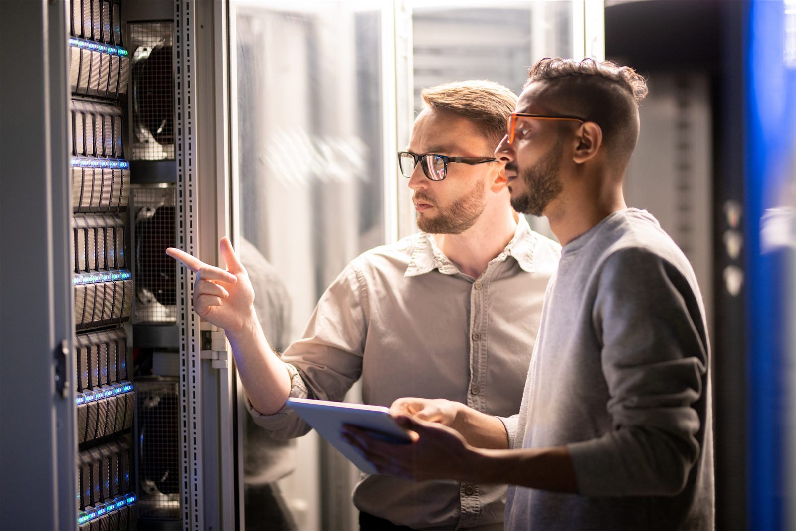 Technical specialists reviewing network server infrastructure